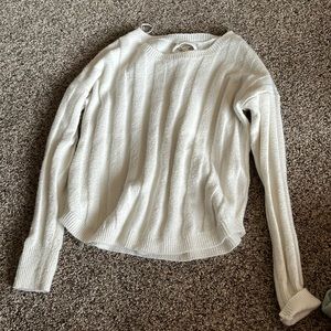 Cute plain white sweater with a fun back.